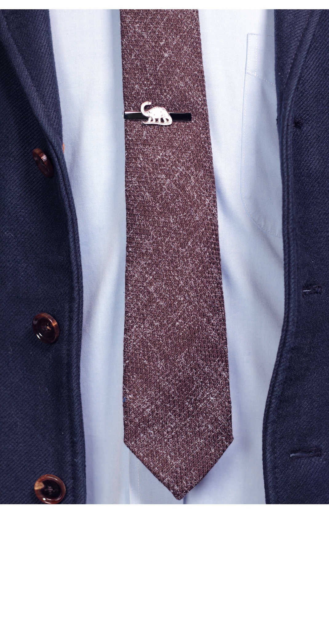white dinosaur on silver tie bar